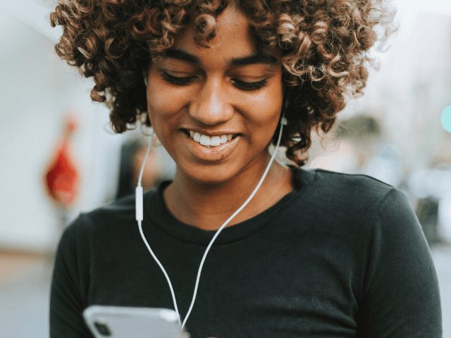 How to beat Instagram Algorithm with hipster black woman with curly hair on her phone. #influencer #bloggingtips