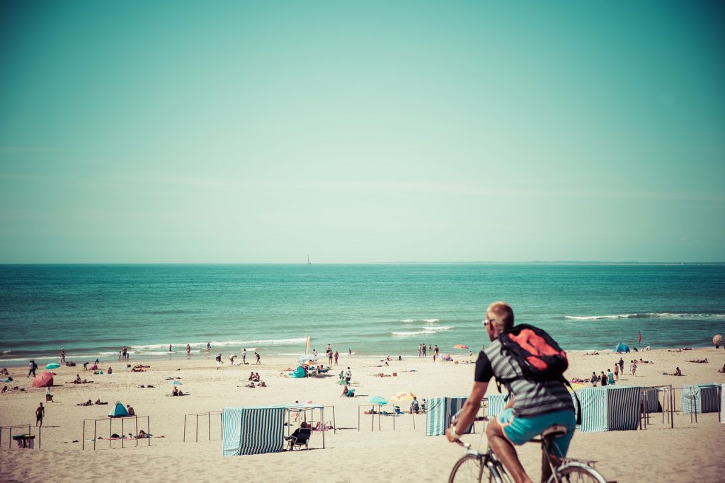 How to beat the Instagram algorithm with lady riding bike on the beach. #instagramtips